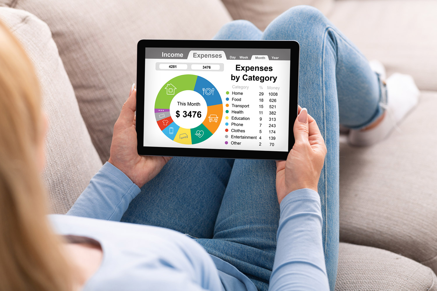 a woman uses one of the best budgeting apps on her tablet