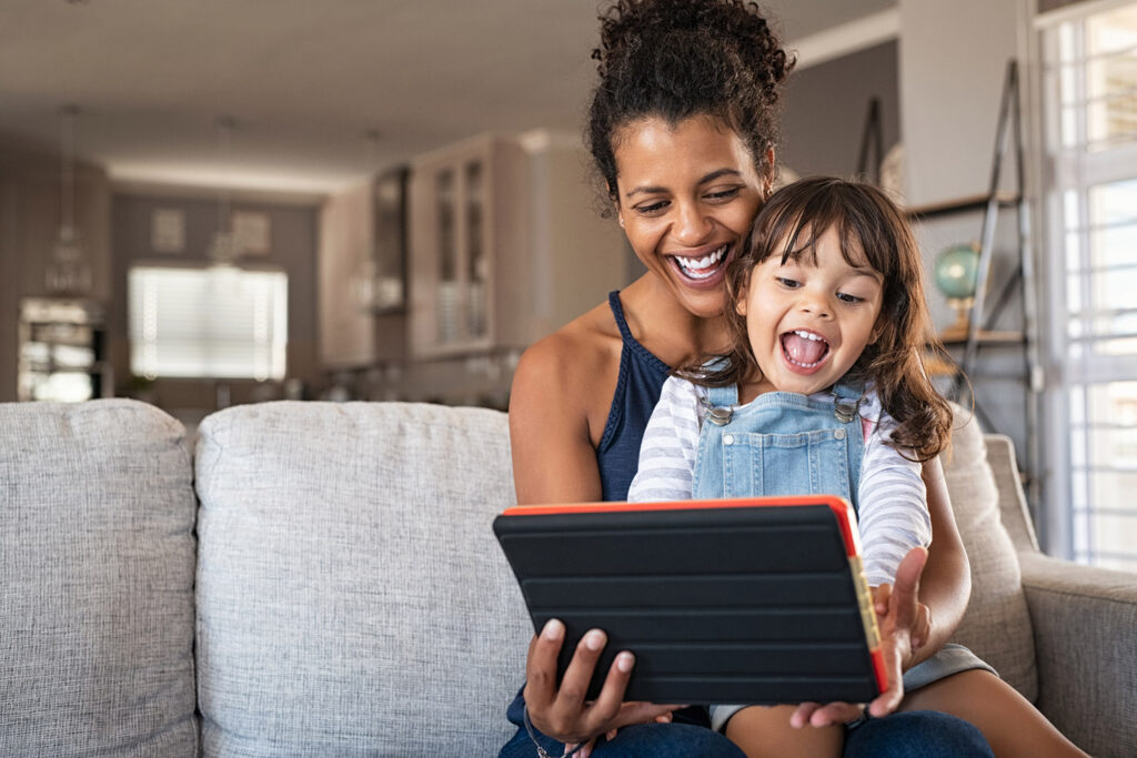 image of a happy mother and daughter using the internet