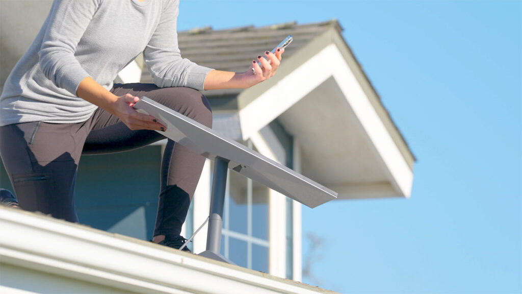 image of a person installing Starlink on the roof of a home